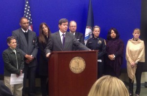Lynchburg prosecutor Michael Doucette at podium, Gil Harrington is far right