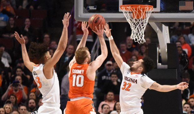 Mar 27, 2016; Chicago, IL, USA; Syracuse Orange guard Trevor Cooney (10) shoots between Virginia Cavaliers guard London Perrantes (32) and forward Anthony Gill (13) during the first half in the championship game of the midwest regional of the NCAA Tournament at United Center. Credit: David Banks-USA TODAY Sports
